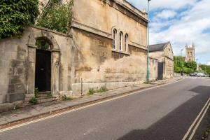 an old building on the side of a street at Look No Further The Stable Block in Beautiful Beaufort House 2 Bedrooms in Bath