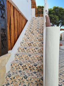 a tile stairway with a mosaic tile floor at La Maison des Vagues in Sidi Kaouki