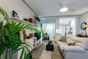 a living room with a white couch and a plant at Audrey by Unique Rooms in Burgos