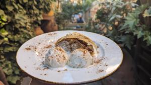 a piece of pie with ice cream on a plate at Guesthouse Kartli in Tbilisi City