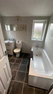 a bathroom with a tub and a toilet and a sink at Pasture Place in Goole