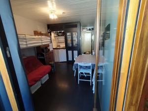 a view of a room with a table and bunk beds at Studio 3 personnes au pied des piste plateau de Bonascre - Ax 3 domaines Eté Hiver in Ax-les-Thermes