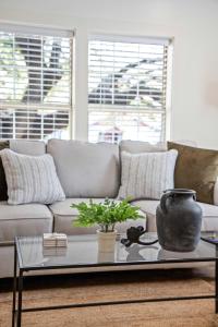 a living room with a couch and a table at Saints Street Charmer in Lafayette