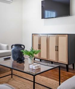 a living room with a coffee table and a tv at Saints Street Charmer in Lafayette