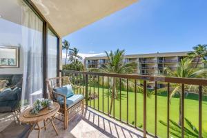 einen Balkon mit einem Stuhl und einem Tisch in der Unterkunft Maui Sunset A404 in Kihei