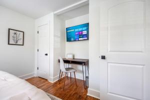 a bedroom with a desk and a bed and a tv at Saints Street Charmer in Lafayette