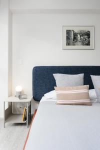 a bedroom with a bed with a blue headboard at Choapan 28 - Lux Apartments in Condesa in Mexico City