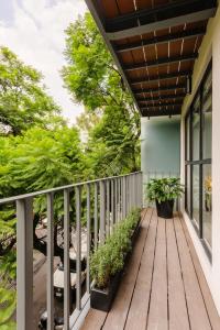 a porch with a wooden deck with plants at Choapan 28 - Lux Apartments in Condesa in Mexico City
