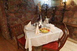 a table with a bowl of fruit on it at Hotel Rubin*** in Gheorgheni +34 photos