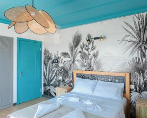 a bedroom with a bed and a mural of plants at Sığacık Gaea Hotel in Izmir +42 photos