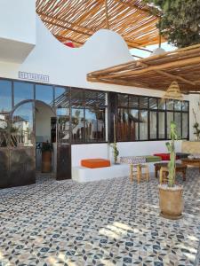 an outdoor patio with a table and chairs and a couch at La Maison des Vagues in Sidi Kaouki