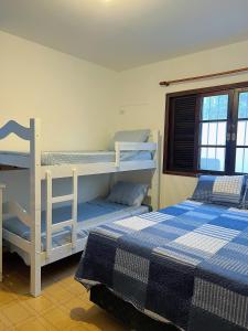 twee stapelbedden in een kamer met twee bedden bij Hostel Coraticum in Ubatuba