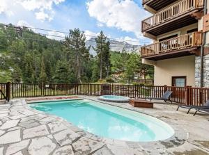 a swimming pool on a patio with a house at ARC 1950 - VUE MONTBLANC & LES ALPES ITALIENNE - Sauna, Hammam, Jacuzzi in Arc 1950