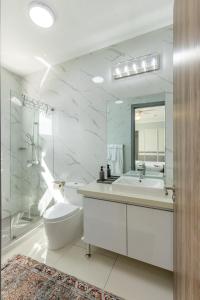 a bathroom with a sink and a toilet and a mirror at Modern Luxury Apartment in New Kingston in Kingston