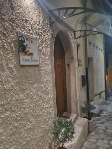 una señal en el lateral de un edificio con una puerta en Casa Vacanze Donna Erminia, en Calitri