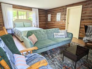 a living room with a couch and a bed at Pilgrim Heights Camp & Retreat Center in Toledo