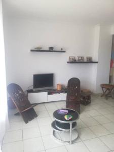 a living room with two chairs and a television at Appartement Saint Raphaël in Saint-Raphaël
