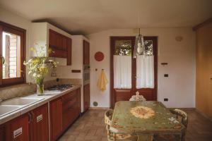 a kitchen with a table and a sink in it at B&B Le Tamerici in San Giorgio di Pesaro