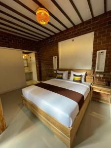 a bedroom with a large bed in a brick wall at MyHome - Lombok in Tetebatu
