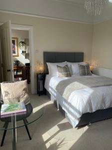 a bedroom with a large bed and a chair at Tranquil Haven Murrayfield in Edinburgh