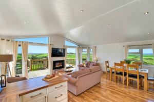 a living room with a couch and a dining room at Finest Retreats - Seacroft in Torpoint