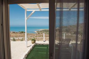 a room with a view of the ocean from a house at Villa Quantum in Siculiana Marina