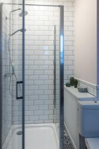 a bathroom with a shower with a toilet and a sink at B&B Destiny in Maldegem
