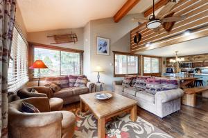 a living room with couches and a table at The Lift #C2 in Angel Fire