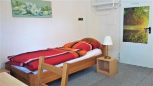 a bedroom with a wooden bed and a lamp at Neuss-Nord in Neuss