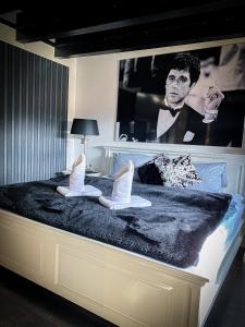 a bedroom with a poster of a man with shoes on a bed at Boutique Hotel Schulz Classic in Neustadt am Rübenberge