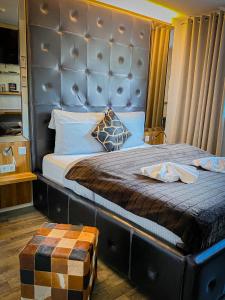 a bedroom with a large bed with a large headboard at Boutique Hotel Schulz Classic in Neustadt am Rübenberge