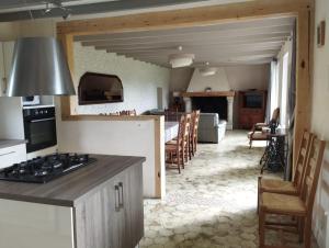 uma cozinha e sala de estar com uma placa de fogão e forno em AU BON CAUCHOIS em Anglesqueville-lʼ Esneval