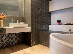 a bathroom with a sink and a bath tub at By La Rambla Rooms in Barcelona
