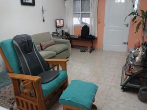 a living room with a couch and a chair at Hospedaje en San Isidro in San Isidro
