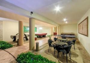 a room with tables and chairs and a pool table at Caribe Grand Dream in Playa del Carmen