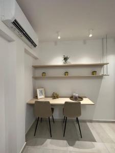 a room with a table and two chairs and shelves at Oculus Kolonaki Apt in Athens