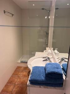 a bathroom with a sink and a shower and a tub at Apartament Riera in Cadaqués