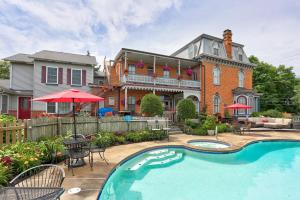 a house with a swimming pool in front of a house at Greystone Manor Bed & Breakfast in Bird-in-Hand
