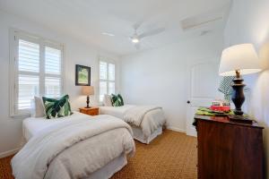 a bedroom with two beds and a table with a lamp at Hale Terra 3br 2ba Beautiful Nihilani Condo, Central AC, Pool, Hot Tub in Princeville +46 photos