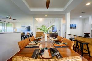 a dining room with a long wooden table and chairs at Hale Terra 3br 2ba Beautiful Nihilani Condo, Central AC, Pool, Hot Tub in Princeville