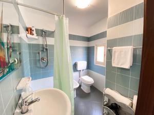 a bathroom with a sink and a toilet at La Ginestra in Corleone +7 photos