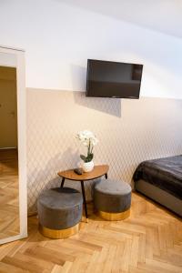 a room with a table with two stools and a bed at ClickTheFlat Pereca City Centre Apart Rooms in Warsaw