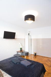 a bedroom with a bed with two chairs and a table at ClickTheFlat Pereca City Centre Apart Rooms in Warsaw