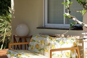einen Stuhl mit einem geblümten Kissen neben einem Fenster in der Unterkunft Habitación Atalaya in Olivella