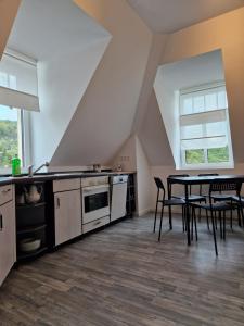 a kitchen and dining room with a table and chairs at Ausblick Freital in Freital