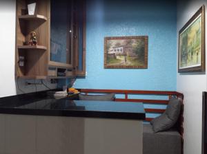 a kitchen with a counter and a couch in a room at Pousada Ramon in Remígio