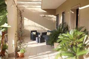 a patio with plants and couches on a house at Ancora del Salento in Lecce