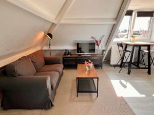 a living room with a couch and a table at Church Square Studio in Zandvoort