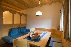 ein Wohnzimmer mit einem blauen Sofa und einem Tisch in der Unterkunft Sonnenheimhof in Mals im Vinschgau
