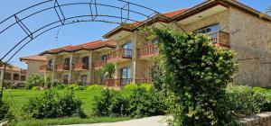 a large building with an arch in front of it at BURHAN'S HOTEL in Rizokarpaso